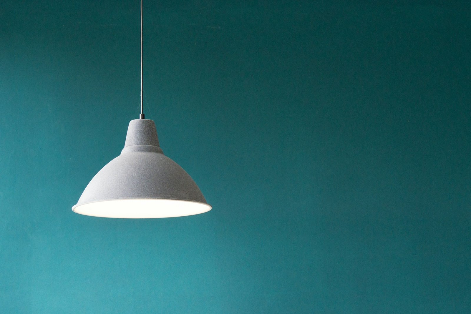 Simple pendant lamp against a deep blue wall